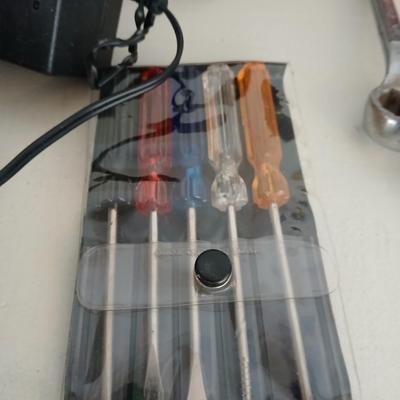 Tool bag with an assortment of tools, Craftsman screwdriver, small screwdriver set, skill screwdriver, a flashlight and more