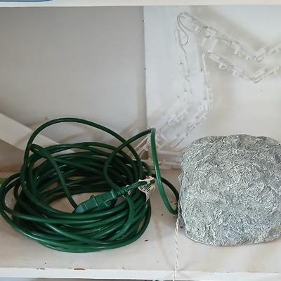 Outdoor Christmas decorations snowflake lights with star an extension cord and a faux hide a cord rock in tote