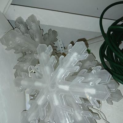 Outdoor Christmas decorations snowflake lights with star an extension cord and a faux hide a cord rock in tote