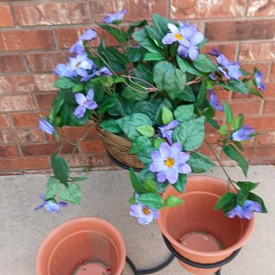 Wrought Iron plant stand with faux purple flowers and two pots