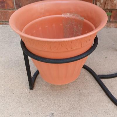 Wrought Iron plant stand with faux purple flowers and two pots