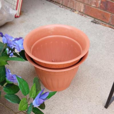 Wrought Iron plant stand with faux purple flowers and two pots