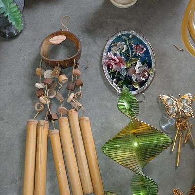 Ceramic plant pots and whirl gig yard art with a new pocket hose