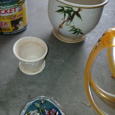 Ceramic plant pots and whirl gig yard art with a new pocket hose