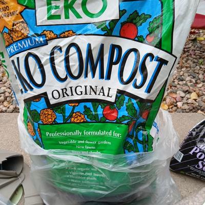 USA Flag on pole, Compost, a new tarp and a few misfit garden items