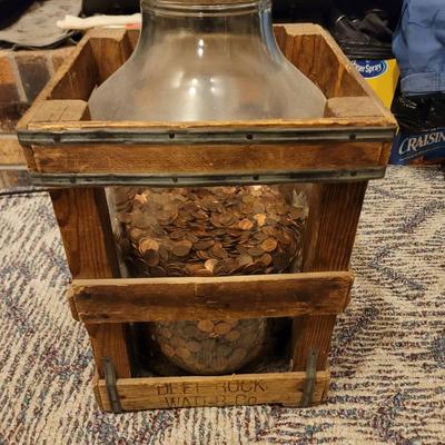 Deet rock water Co crate and big jar of pennies