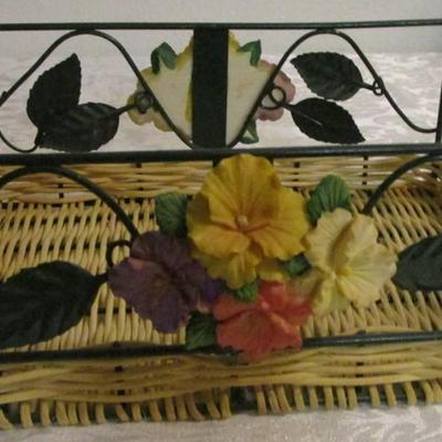 Metal and wicker basket with resin flowers and handles