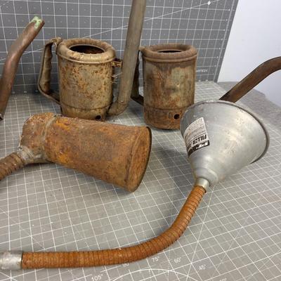 Pile of Vintage Oil Cans and Funnels
