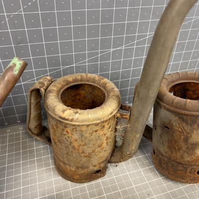 Pile of Vintage Oil Cans and Funnels