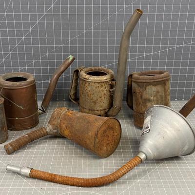 Pile of Vintage Oil Cans and Funnels