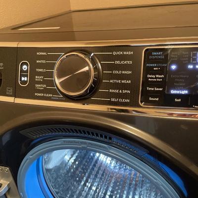 GE front load washer and dryer on pedestals