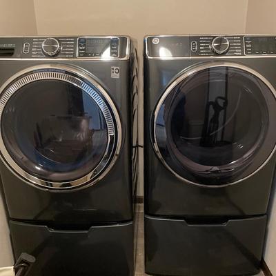 GE front load washer and dryer on pedestals