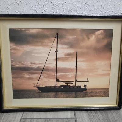 Sale Photo Thumbnail #70: Framed and matted image of a sailboat at sunrise.