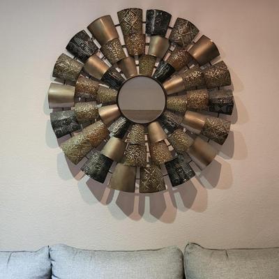 Metal wall decor with round, center mirror