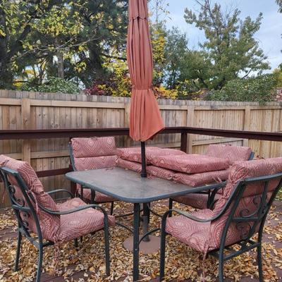 Lot includes 4 outdoor chairs, 1 outdoor table, and 1 umbrella
