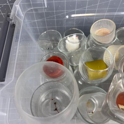 Tub Full of Glass Votive Holders and Mixed Colored Candles