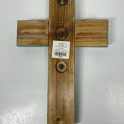 Painted wood cross with large nails or spikes.