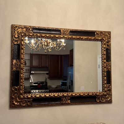 Black and gold adorned mirror