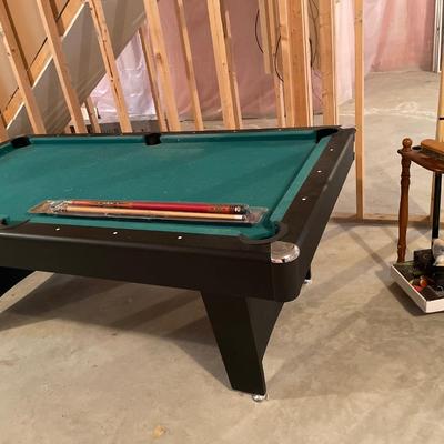 Smaller pool table with cues and stand