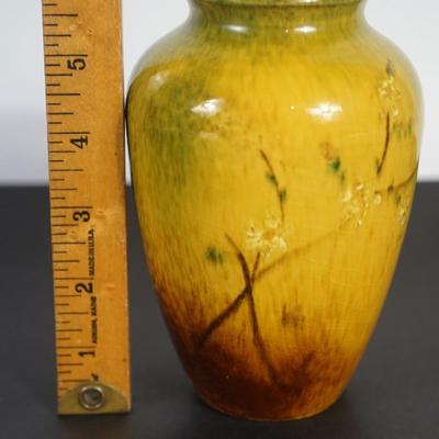 Sale Photo Thumbnail #6: 6"  vase stamped Rock Pottery Edgerton 47 M/ is

Date of production 1894-1901 The molds from Pauline pottery possibly used but not affiliated with Pauline pottery. 

High gloss glaze with mustard yellow color and brown hue. Wildflowers decorated
No damage