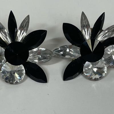 Sale Photo Thumbnail #245: One pair is a clip on dark flower blossom, the other pierced ear pair combines black and rhinestone flowers petals with 2 round rhinestones. In very good vintage condition