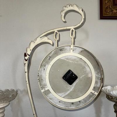 HANGING CLOCK ON AN IRON FRAME AND 2 FLOOR PILLAR CANDLE HOLDERS