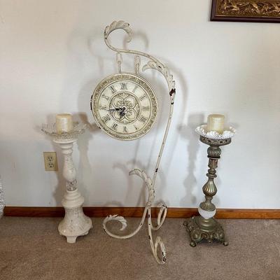 HANGING CLOCK ON AN IRON FRAME AND 2 FLOOR PILLAR CANDLE HOLDERS