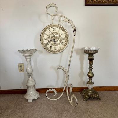 HANGING CLOCK ON AN IRON FRAME AND 2 FLOOR PILLAR CANDLE HOLDERS