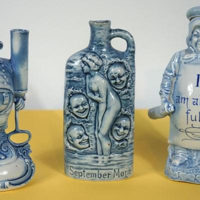 GROUPING OF THREE BLUE AND WHITE GERMAN CHARACTER PORCELAIN LIQUOR FLASKS