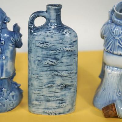 GROUPING OF THREE BLUE AND WHITE GERMAN CHARACTER PORCELAIN LIQUOR FLASKS