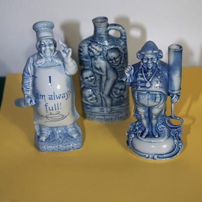 GROUPING OF THREE BLUE AND WHITE GERMAN CHARACTER PORCELAIN LIQUOR FLASKS
