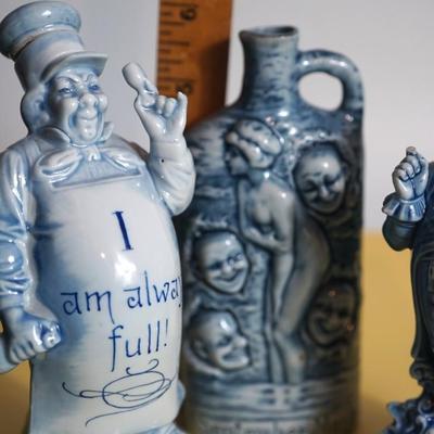 GROUPING OF THREE BLUE AND WHITE GERMAN CHARACTER PORCELAIN LIQUOR FLASKS