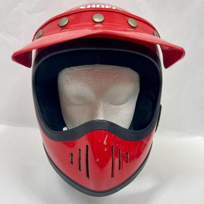 Sale Photo Thumbnail #409: Bright Red. Size Medium (7 1/8 - 7 1/4). Produced in 1984. Good overall condition, some chips in the outer shell from flying sand/rocks.  Snap-on plastic sun visor. Chin strap and liner in good condition, see photos.