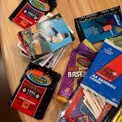 Multiple packs of opened baseball cards