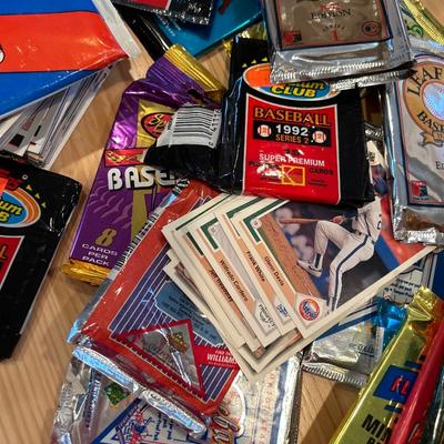 Multiple packs of opened baseball cards