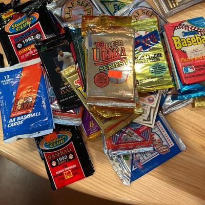 Multiple packs of opened baseball cards