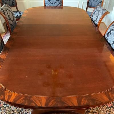 Sale Photo Thumbnail #4: Beautiful Flamed Mahogany Edge with Banded Detail  measuring 80" long x 48" wide x 30.25" high 
Extended total length is 128" with the 3- 16" leaves 
Comes with pads 
Two arm chairs and 6 dining chairs