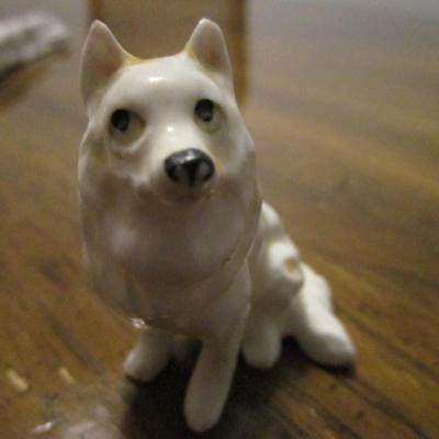 3 white ceramic American Eskimo dogs