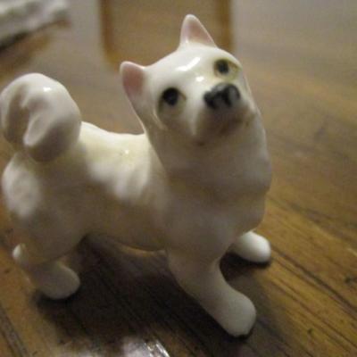 3 white ceramic American Eskimo dogs