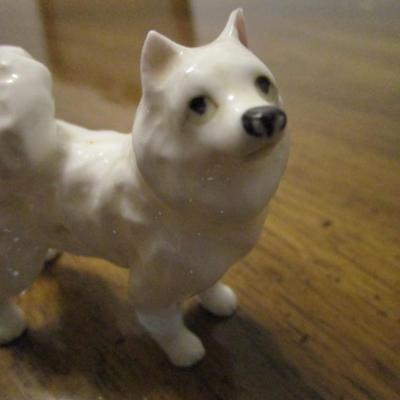 3 white ceramic American Eskimo dogs