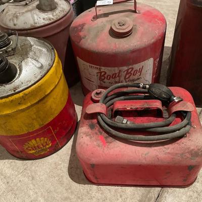Multiple vintage gas cans