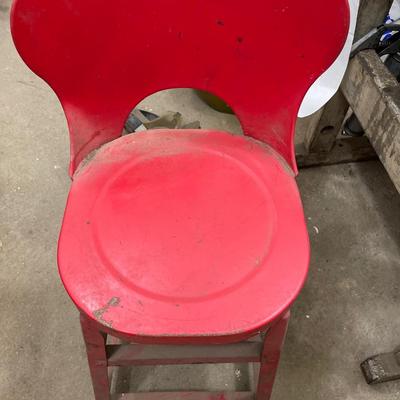 Small red stool with solvent parts cleaner