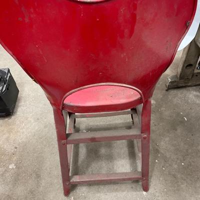 Small red stool with solvent parts cleaner