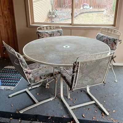 54" Wrought iron mesh patio table with 4 wrought iron mesh chairs and cushions