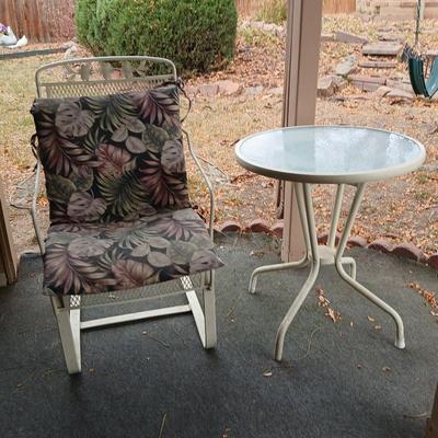 Wrought iron mesh patio chair with cushion and metal base glass topped patio table