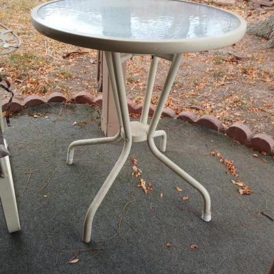 Wrought iron mesh patio chair with cushion and metal base glass topped patio table
