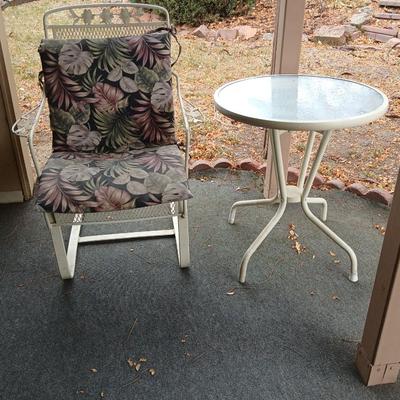 Wrought iron mesh patio chair with cushion and metal base glass topped patio table