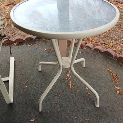 Wrought iron mesh patio chair with cushion and metal base glass topped patio table