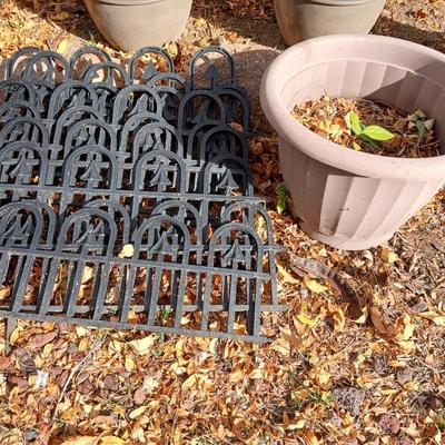 9 black connecting plastic fence pieces with a large flowerpot