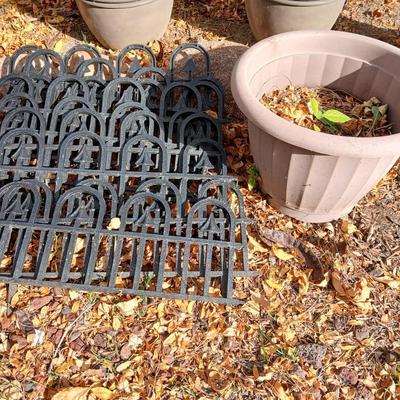 9 black connecting plastic fence pieces with a large flowerpot
